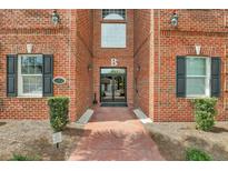 Brick building with double glass doors, black shutters, and a walkway at 1443 Cambridge Lakes Dr, Mount Pleasant, SC 29464