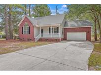Brick house with attached garage and driveway at 195 Fox Squirrel Run, Summerville, SC 29483
