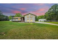 Two-story house with attached garage and landscaping at 225 Cantering Hills Ln, Summerville, SC 29483