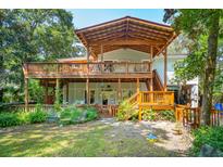 Home with a large deck and spacious backyard at 412 E Hudson Ave, Folly Beach, SC 29439