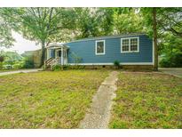 Blue house with a wooden porch and a grassy yard at 2355 Cambridge Ave, North Charleston, SC 29405