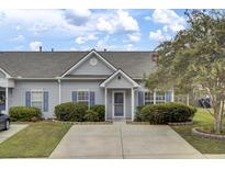 Grey house with blue shutters and landscaped yard at 161 Townsend Way, Summerville, SC 29483
