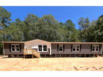 Single-Gathering home with gray siding and a wooden deck at 928 Tiger Loop, Saint Stephen, SC 29479