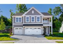 Two-story house featuring a gray exterior, three-car garage, and a front porch at 109 Grange Cir, Summerville, SC 29483