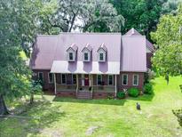 Brick house with metal roof, large porch, and spacious yard at 1813 Albert Storm Ave, Moncks Corner, SC 29461
