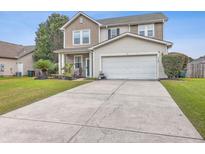 Two-story house with a two-car garage and landscaped lawn at 7160 Sweetgrass Blvd, Hanahan, SC 29410