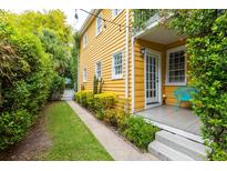 Charming yellow house with a side yard and small patio at 167 Coming St, Charleston, SC 29403