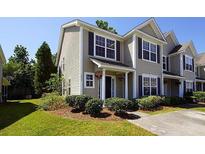 Tan two-story home with dark shutters and landscaping at 2429 Scholar Ln, North Charleston, SC 29406