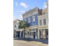 Three story commercial building with blue facade and street view at 377 King St # 101, Charleston, SC 29401