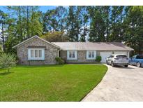 Brick ranch house with a metal roof, two-car garage, and a well-maintained lawn at 305 Foxhound Court, Goose Creek, SC 29445