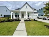 Charming farmhouse exterior with a welcoming front porch at 113 Medford St, Summerville, SC 29486