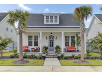Charming white cottage with a welcoming front porch at 661 Blueway Ave, Summerville, SC 29486