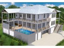Three-story home with pool and attached garage, offering expansive outdoor space at 3703 Hartnett Blvd, Isle of Palms, SC 29451