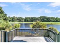Deck overlooking a tranquil lake and golf course at 4910 Green Dolphin Way, Kiawah Island, SC 29455
