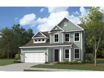 Two-story house with a green exterior and a white garage door at 9 Tidewater Ln, Summerville, SC 29486