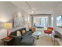 Open living space with sectional sofa and large TV at 487 King St # 201, Charleston, SC 29403