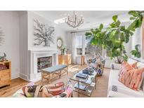 Bright living room with fireplace, large windows, and stylish furnishings at 9844 Haven Loop, Johns Island, SC 29455
