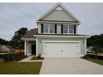 Two-story house with light green siding and white garage door at 173 Cantona Dr, Summerville, SC 29483