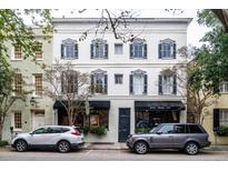 Two-story building with commercial spaces and dark shutters at 106 Church St # D, Charleston, SC 29401