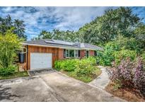 Ranch style home with attached garage and landscaping at 148 Chadwick Dr, Charleston, SC 29407