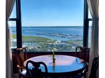 Dining room with bay window offering scenic water views at 14 Lockwood Dr # 10D, Charleston, SC 29401