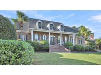 Two story house with front porch and landscaping at 1000 Rivershore Rd, Charleston, SC 29492