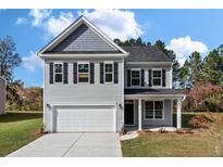 Two-story gray house with white garage door and black shutters at 2802 Lacy St, North Charleston, SC 29406