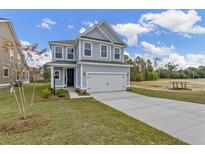 Two-story Craftsman home with gray siding, white trim, and a two-car garage at 424 Grove End Rd, Moncks Corner, SC 29461
