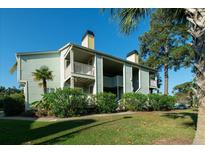 Two-story building with light green siding, balconies, and landscaping at 1481 Center Extension St # 208, Mount Pleasant, SC 29464