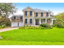 Two-story house with a two-car garage and landscaped yard at 690 Hunt Club Run, Charleston, SC 29414