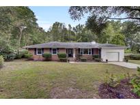 Brick ranch house with attached garage and manicured lawn at 205 Whitesville Rd, Moncks Corner, SC 29461