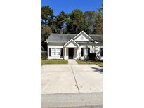 White house with black shutters and a concrete driveway at 106 Hardee Ave, Summerville, SC 29485