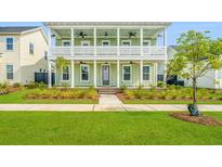 Two story home with front porch and landscaped yard at 276 Clearpath Dr, Summerville, SC 29486
