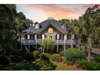 Stunning two-story home with large covered porch and beautiful landscaping at 3906 Heron Marsh Cir, Johns Island, SC 29455