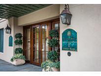 Elegant building entrance with lush landscaping and ornate details at 1 Vendue Range # D, Charleston, SC 29401