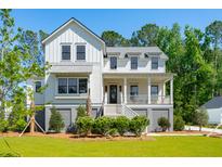 Stunning two-story farmhouse with gray accents and a spacious yard at 1480 Jeremy Cay Ct, Awendaw, SC 29429