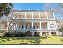 Two story pink home with white columns and wrap around porch at 192 Ashley Ave # C, Charleston, SC 29403