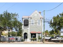 Charming two-story building with a red roof and storefront at 240 Calhoun St, Charleston, SC 29401