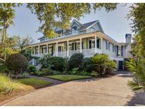 Two-story home with large porch and lush landscaping at 1311 S Jenkins Lagoon Dr, Seabrook Island, SC 29455