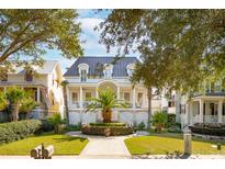 Two story home with a metal roof, front porch, and manicured lawn at 738 Hibbens Grant Blvd, Mount Pleasant, SC 29464