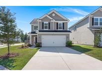 Two-story home with gray siding and two-car garage at 213 Lazy River Ln, Moncks Corner, SC 29461