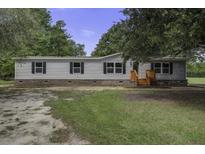 Single-wide manufactured home with landscaped yard at 1653 Short Cut Rd, Cross, SC 29436