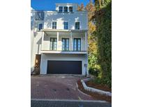 Three-story house with a two-car garage and front porch at 22 Iron Forge Aly, Charleston, SC 29403