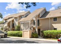 Tan colored building exterior with parking at 121 High Hammock Villas # 121, Seabrook Island, SC 29455