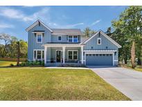 Two-story farmhouse with blue siding, white trim, and a metal roof at 2261 Norwood Oaks Dr, Mount Pleasant, SC 29466