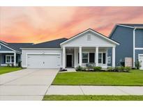 Two-story home with front porch and landscaped yard at 619 Macintyre Cir, Summerville, SC 29486