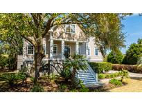 Two-story house with a front porch and lush landscaping at 4233 Haulover Dr, Johns Island, SC 29455
