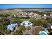 Waterfront community with various houses and a pool at 2418 Racquet Club Dr, Seabrook Island, SC 29455