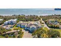 Aerial view of a waterfront property with a main house, pool, and ocean views at 1735 Atlantic Ave, Sullivans Island, SC 29482