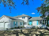 White brick home with teal shutters and a teal door at 1894 Capri Dr, Charleston, SC 29407